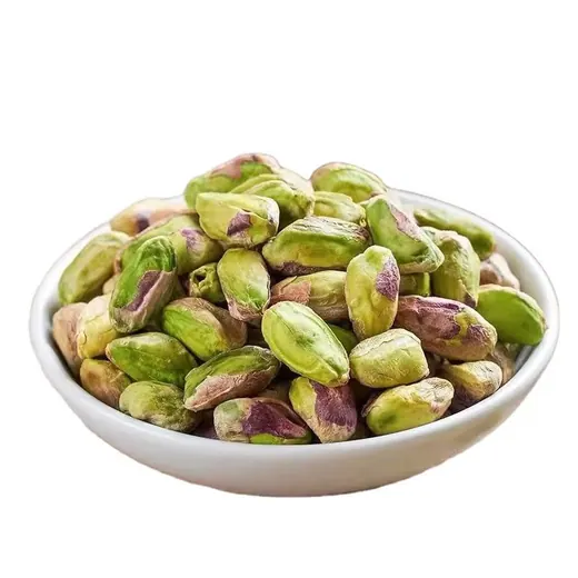 Green pistachio kernels in a bowl